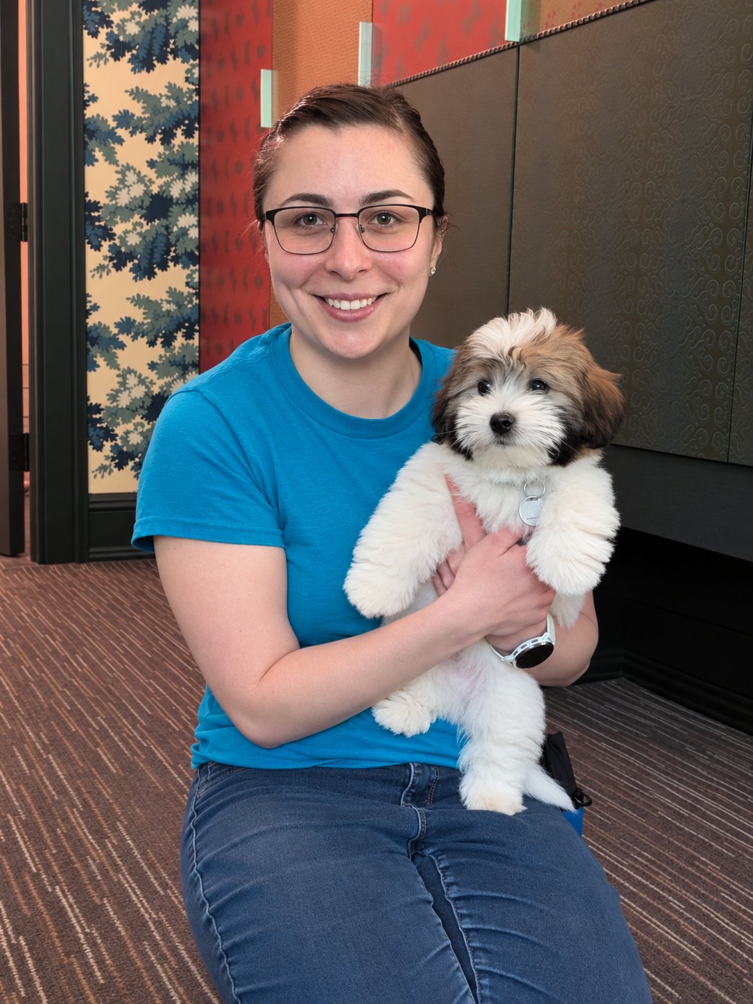 Carly holding a fluffy puppy
